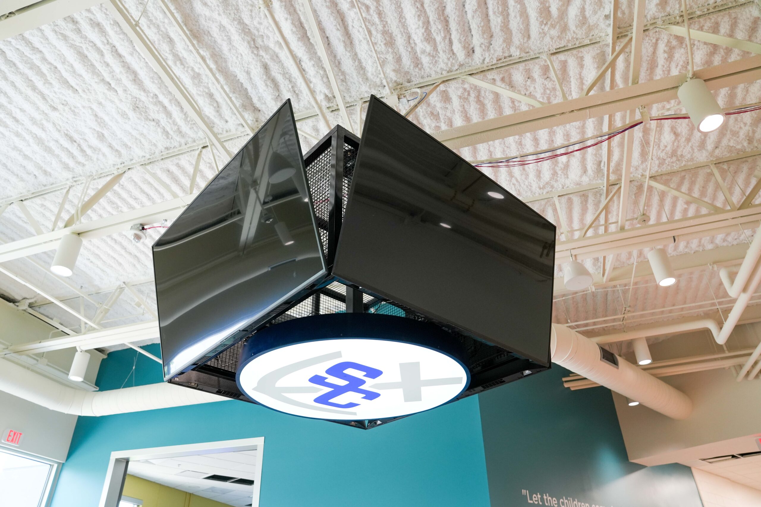Digital display with South Christian High School logo installed in the commons area, featuring Buist’s audio-visual and electrical integration.