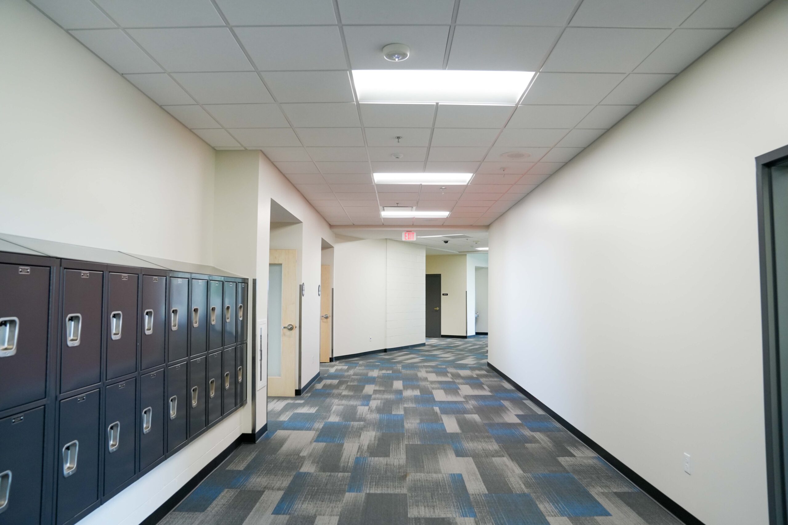 Modern interior hallway with lockers and overhead lighting at South Christian High School, installed by Buist.