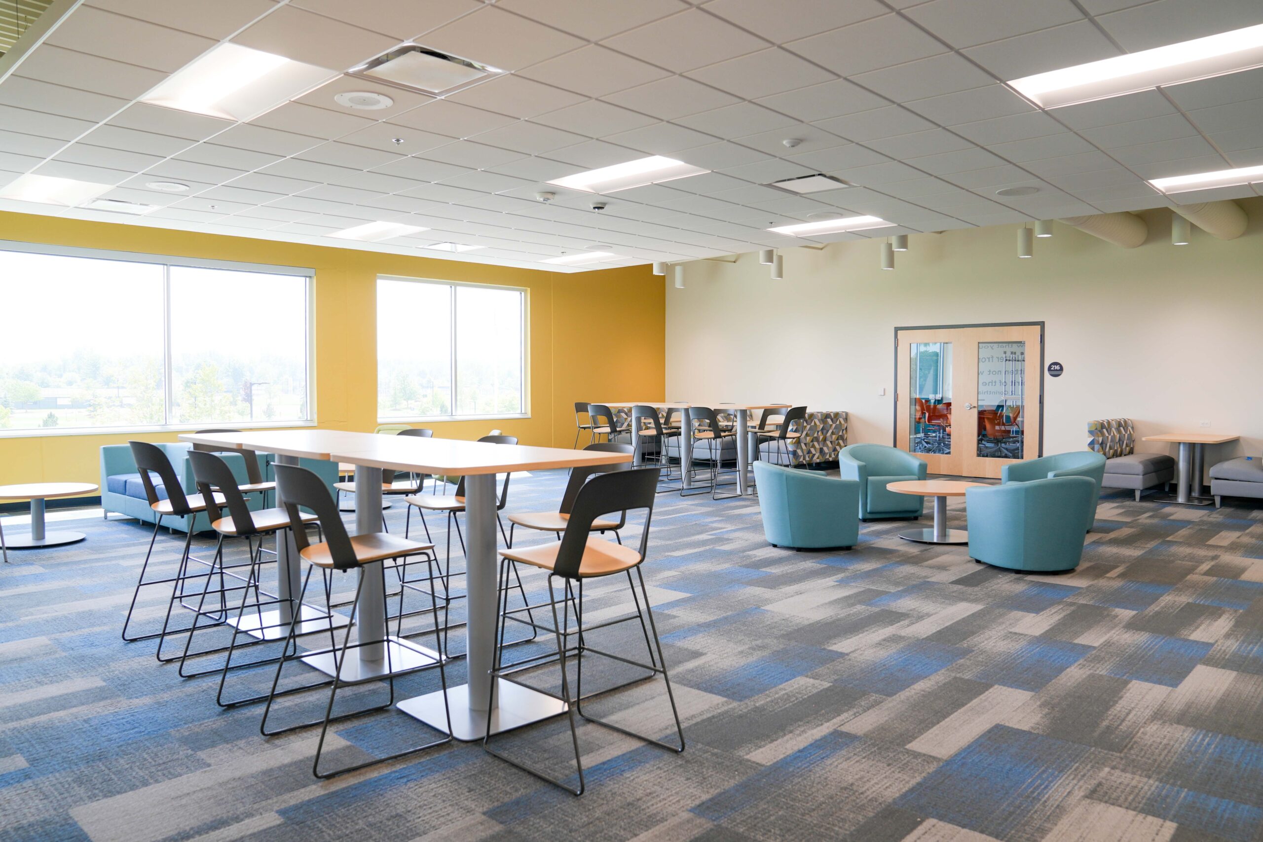 Student collaboration space with modern furniture and natural light at South Christian High School, supported by Buist’s electrical contracting work.