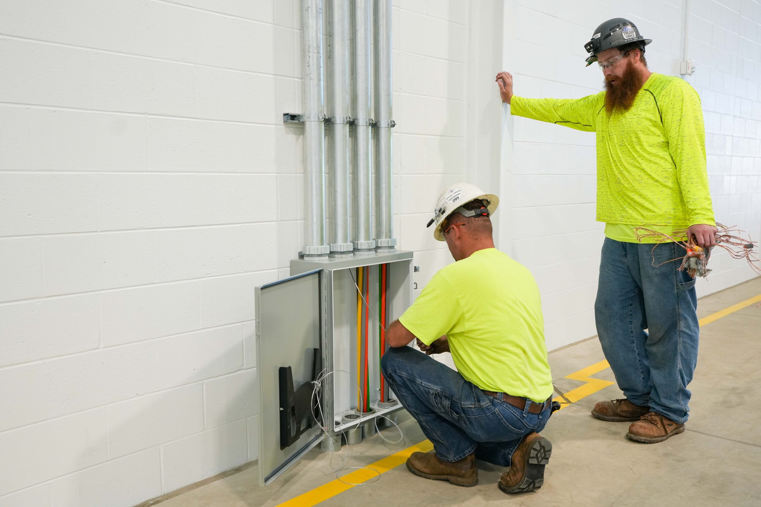 Buist electricians installing and inspecting conduit and electrical panel connections.
