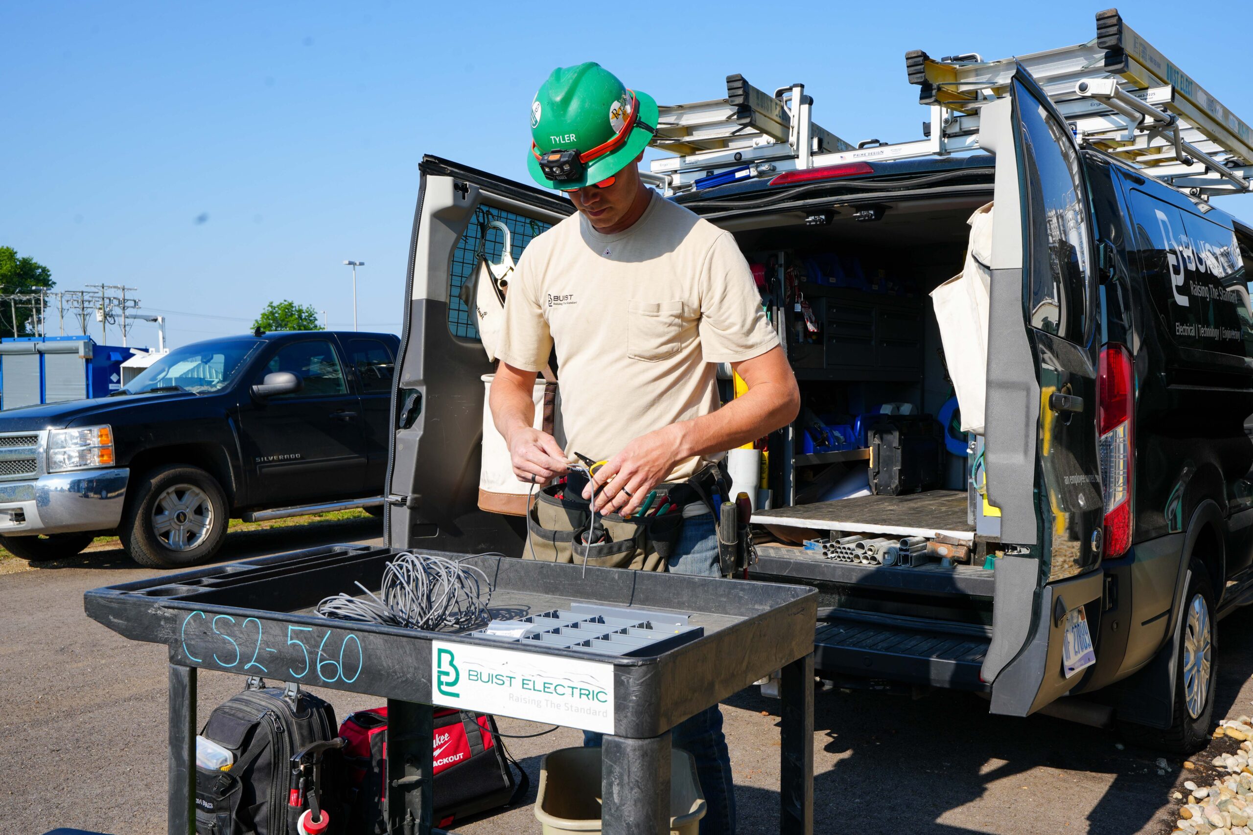 Buist service technician preparing electrical wiring at jobsite service van.