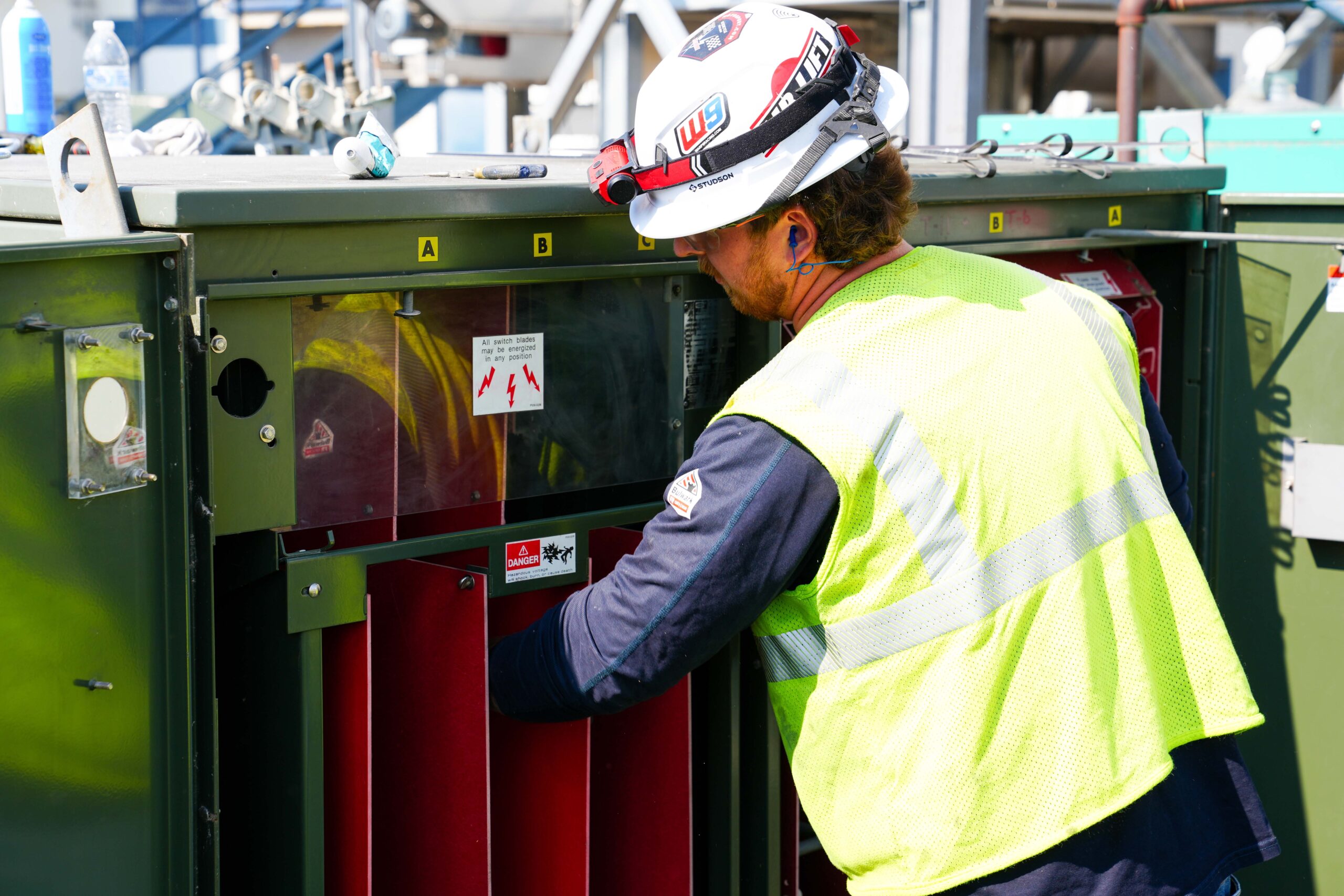 Buist technician inspecting and maintaining a padmount transformer.