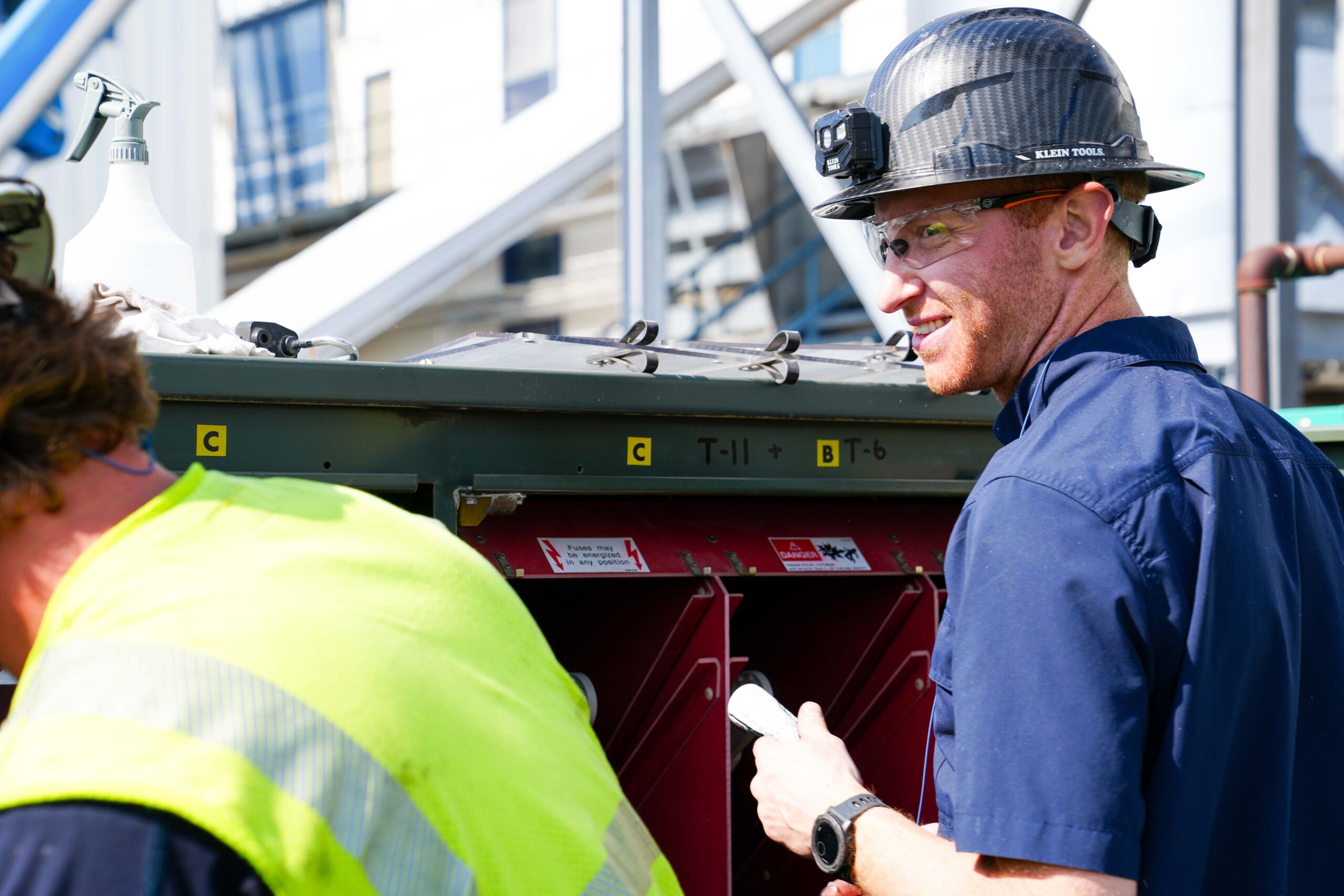 Buist technician conducting outdoor transformer inspection and maintenance.