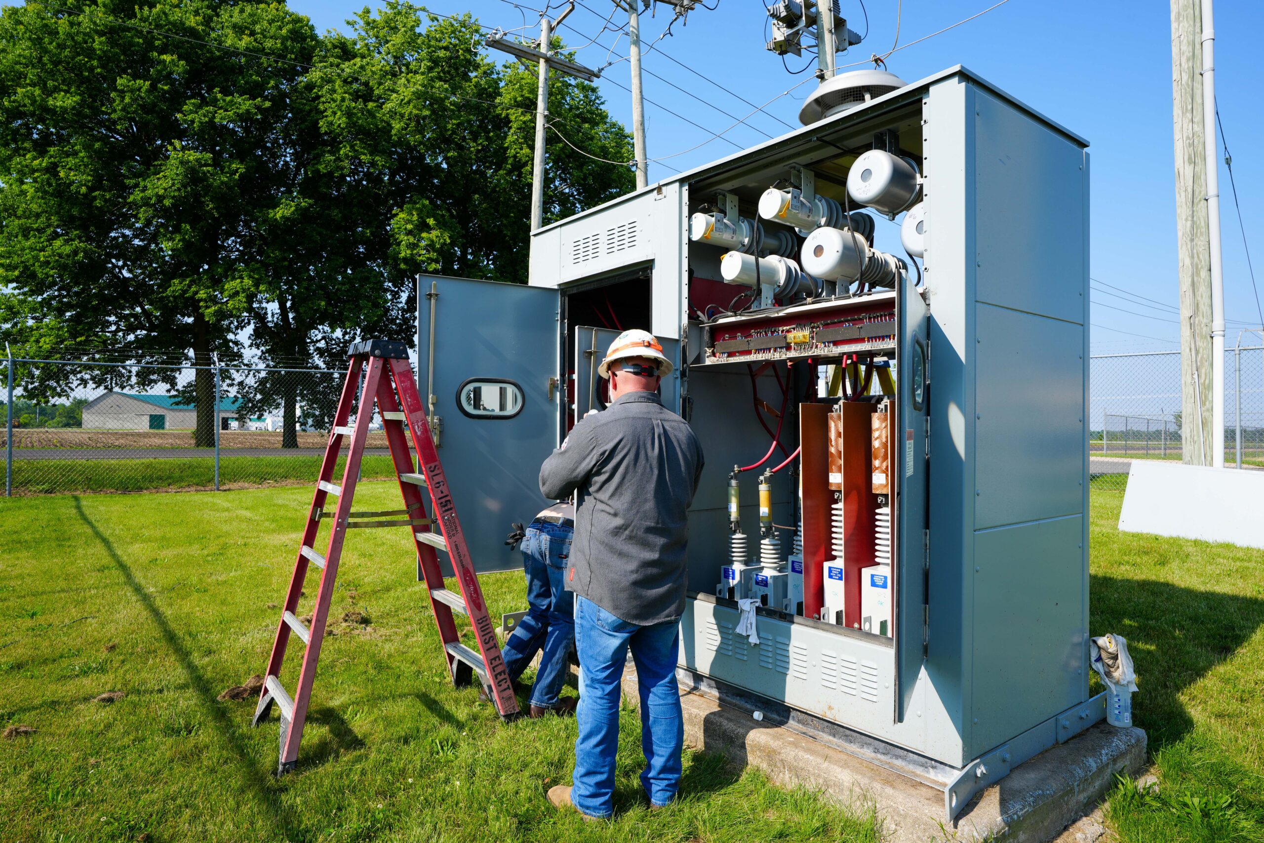 Buist technician performing testing and inspection on outdoor transformer.
