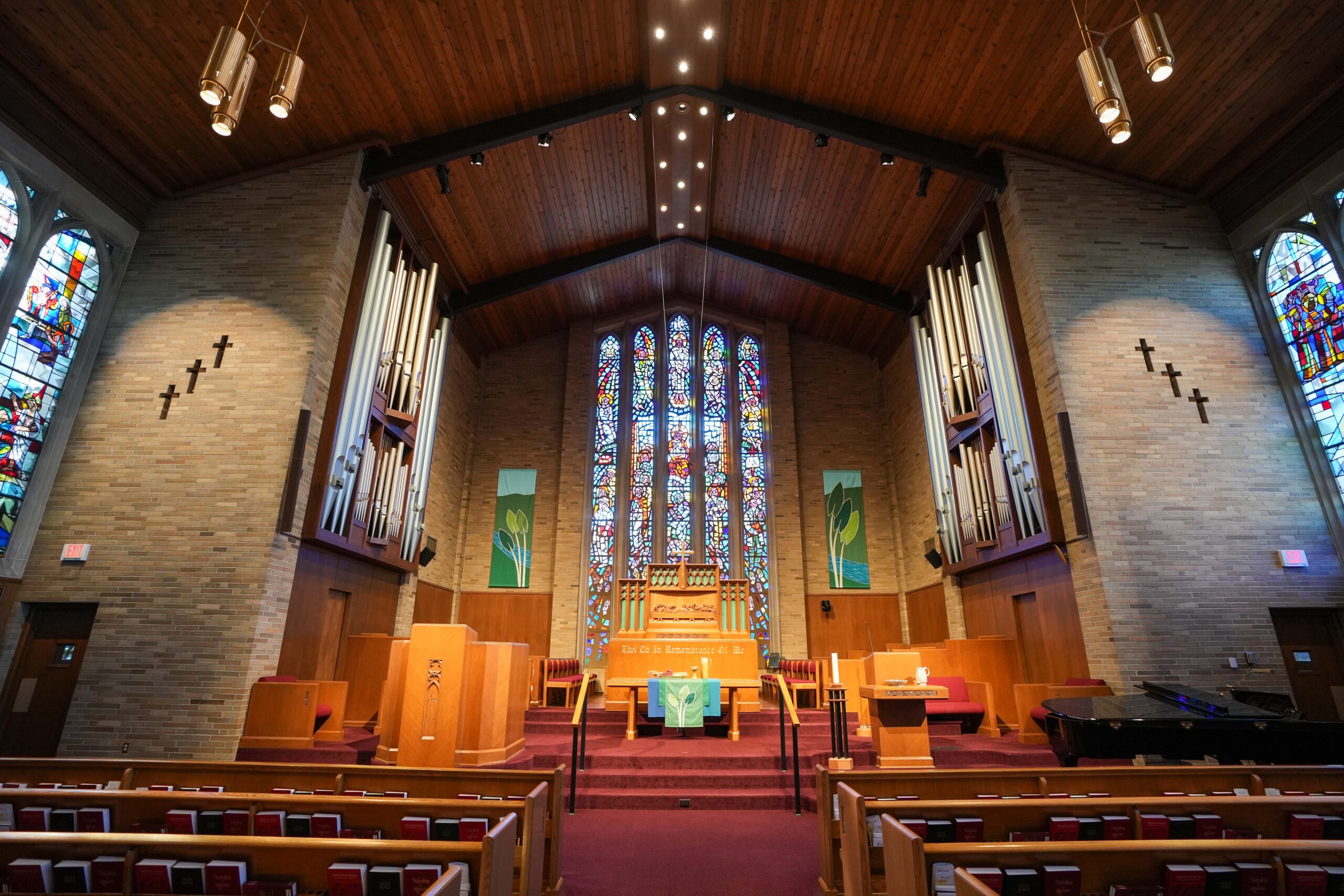 Altar and pipe organ at LaGrave Avenue Christian Reformed Church in Grand Rapids, featuring stained-glass windows and upgraded sanctuary lighting.