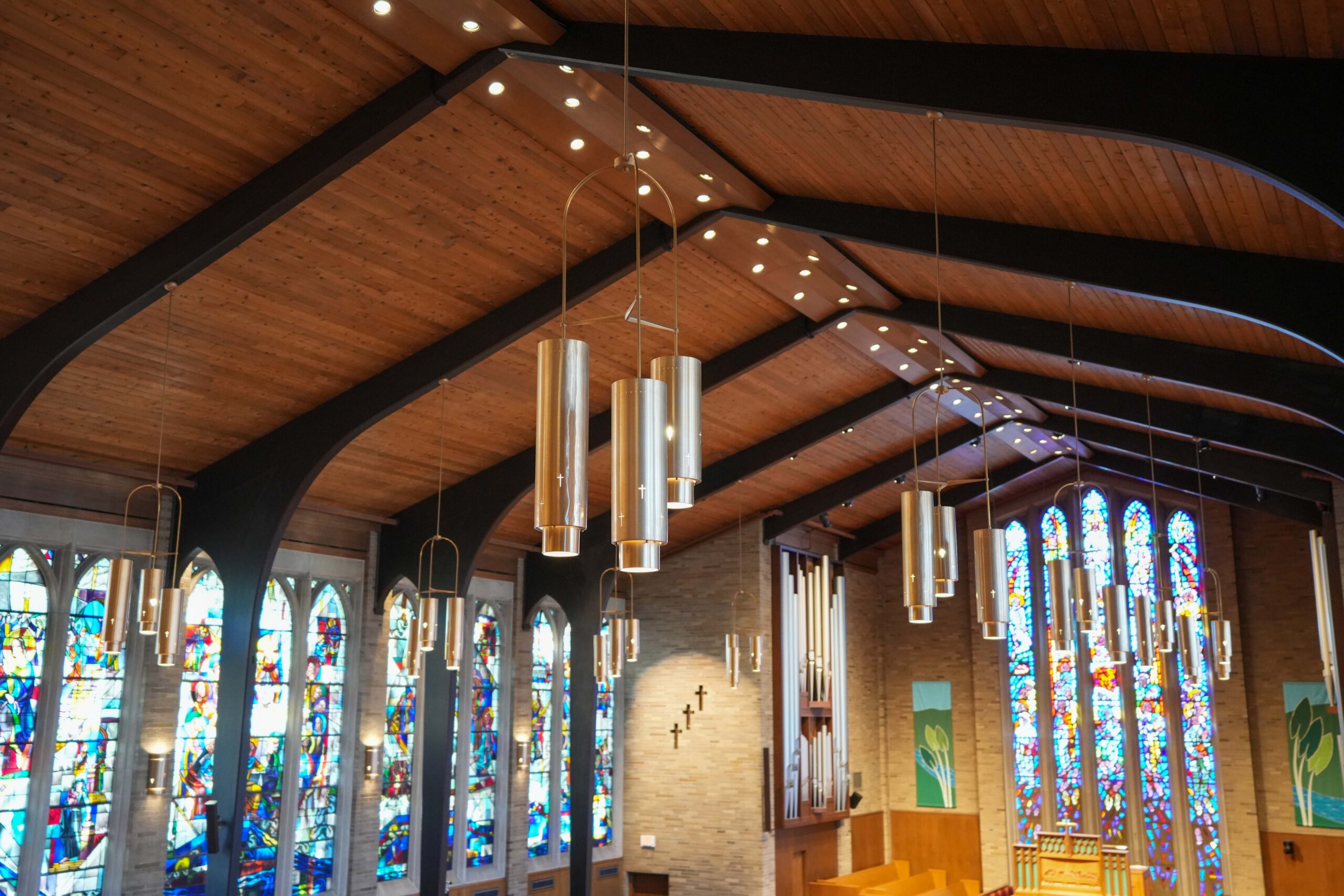 New sanctuary light fixtures at LaGrave Avenue Christian Reformed Church in Grand Rapids with stained-glass windows in the background.