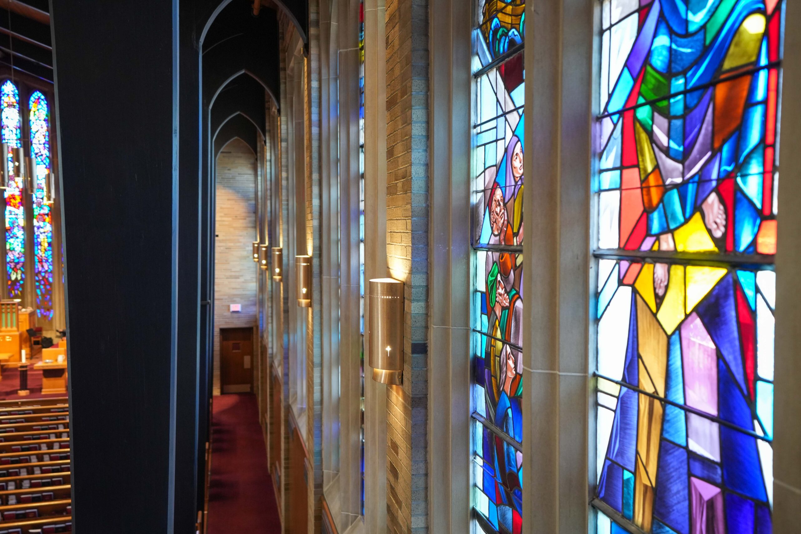 Detailed view of stained-glass windows at LaGrave Avenue Christian Reformed Church in downtown Grand Rapids, enhanced by upgraded lighting.