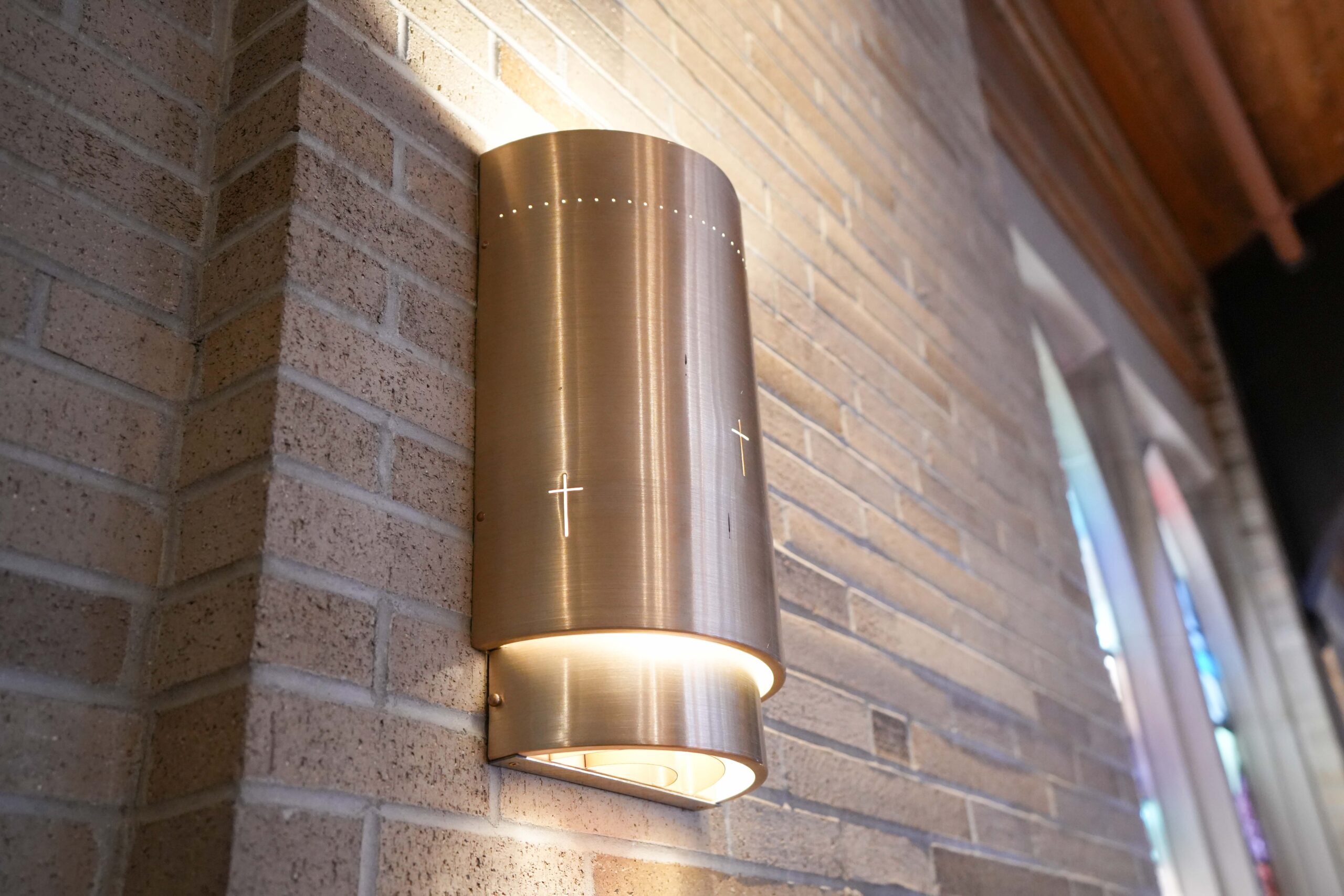 Close-up of new wall light fixture with cross detail inside LaGrave Avenue Christian Reformed Church sanctuary in Grand Rapids installed by Buist.