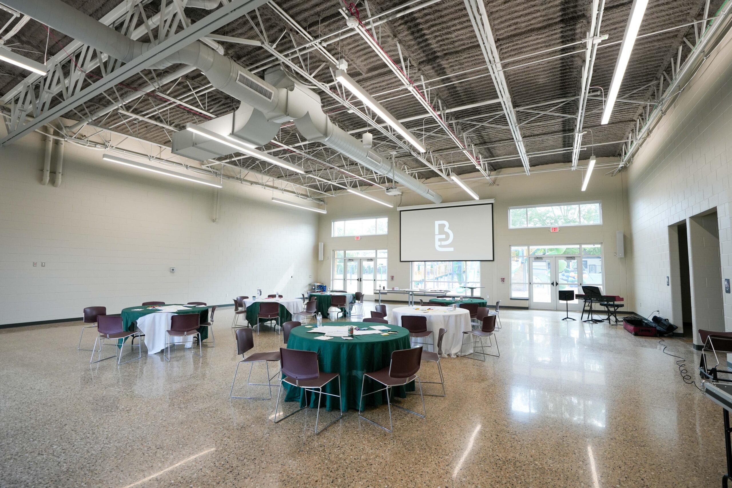 Multi-purpose room at Moline Christian School with new lighting, audio-visual, and power solutions installed by Buist.