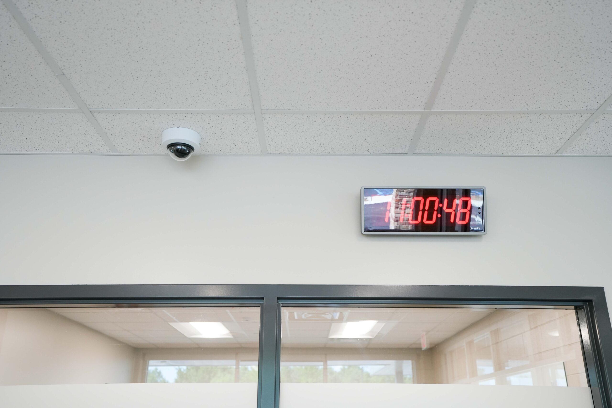 Security camera and synchronized digital clock installed at Moline Christian School by Buis
