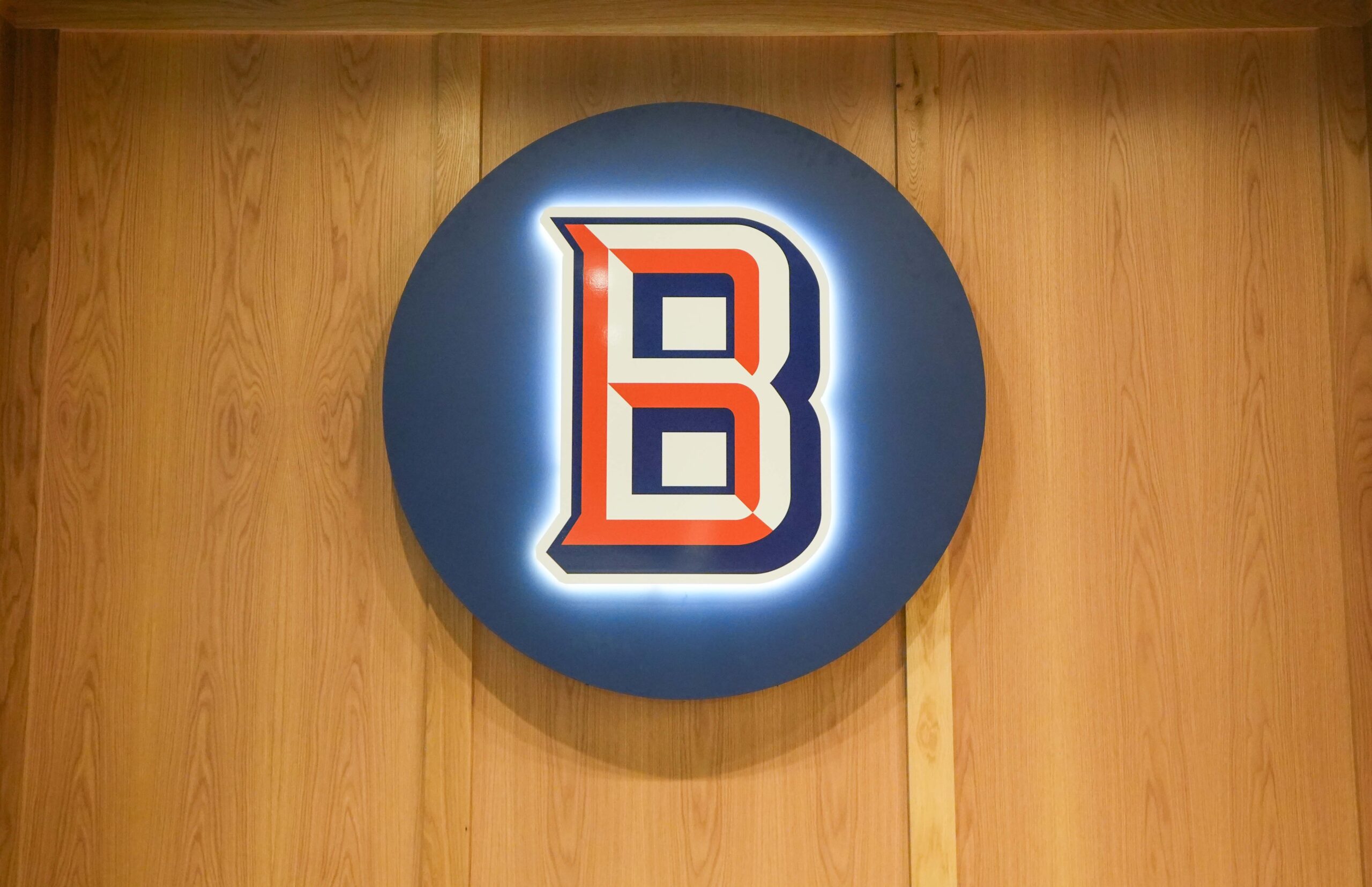 Backlit Burdick’s Bar & Grill “B” logo mounted on a wood accent wall at the Radisson Plaza Hotel in Kalamazoo.