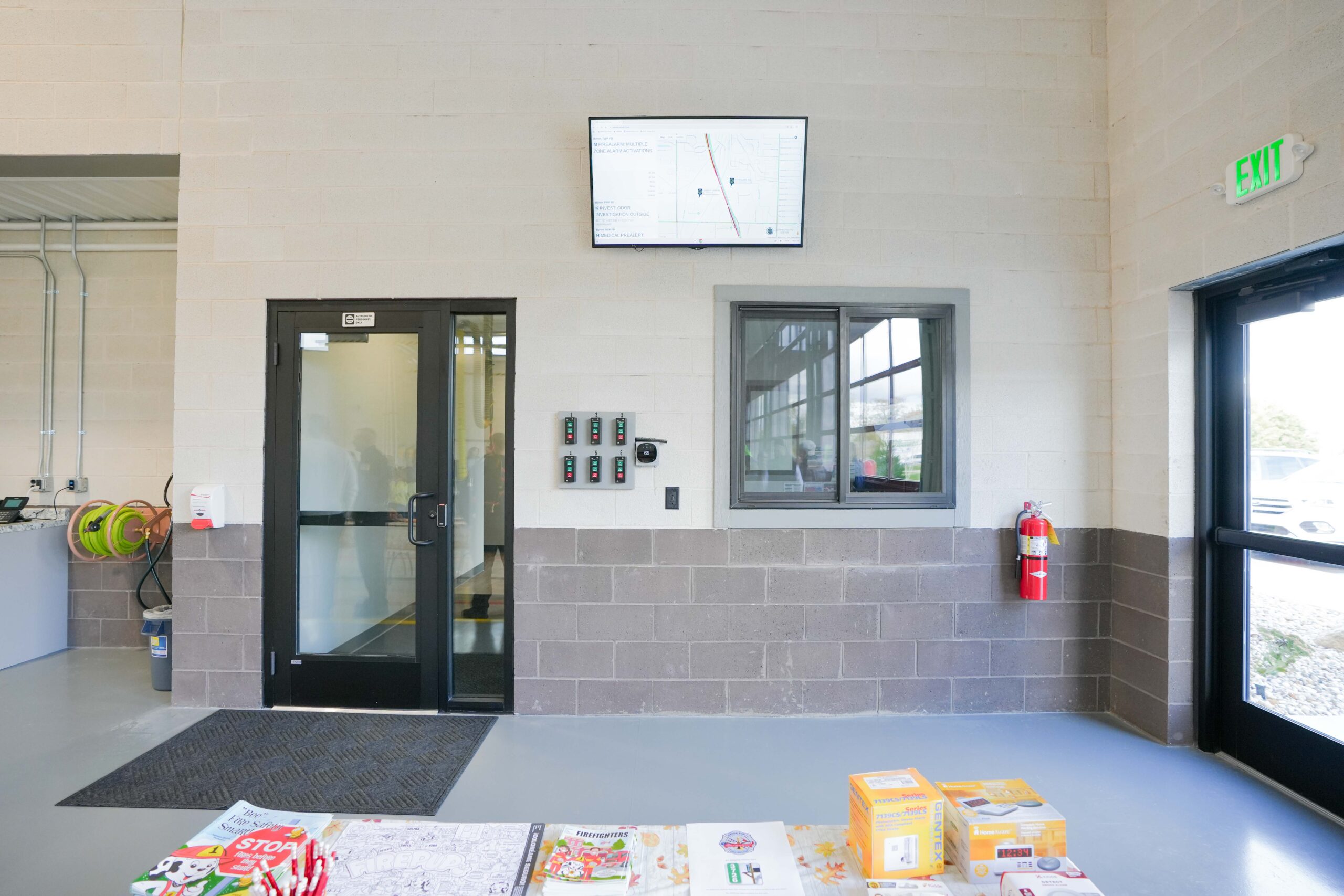 Access-controlled entry point at Byron Township Fire Department featuring Buist-installed security readers and wall display.