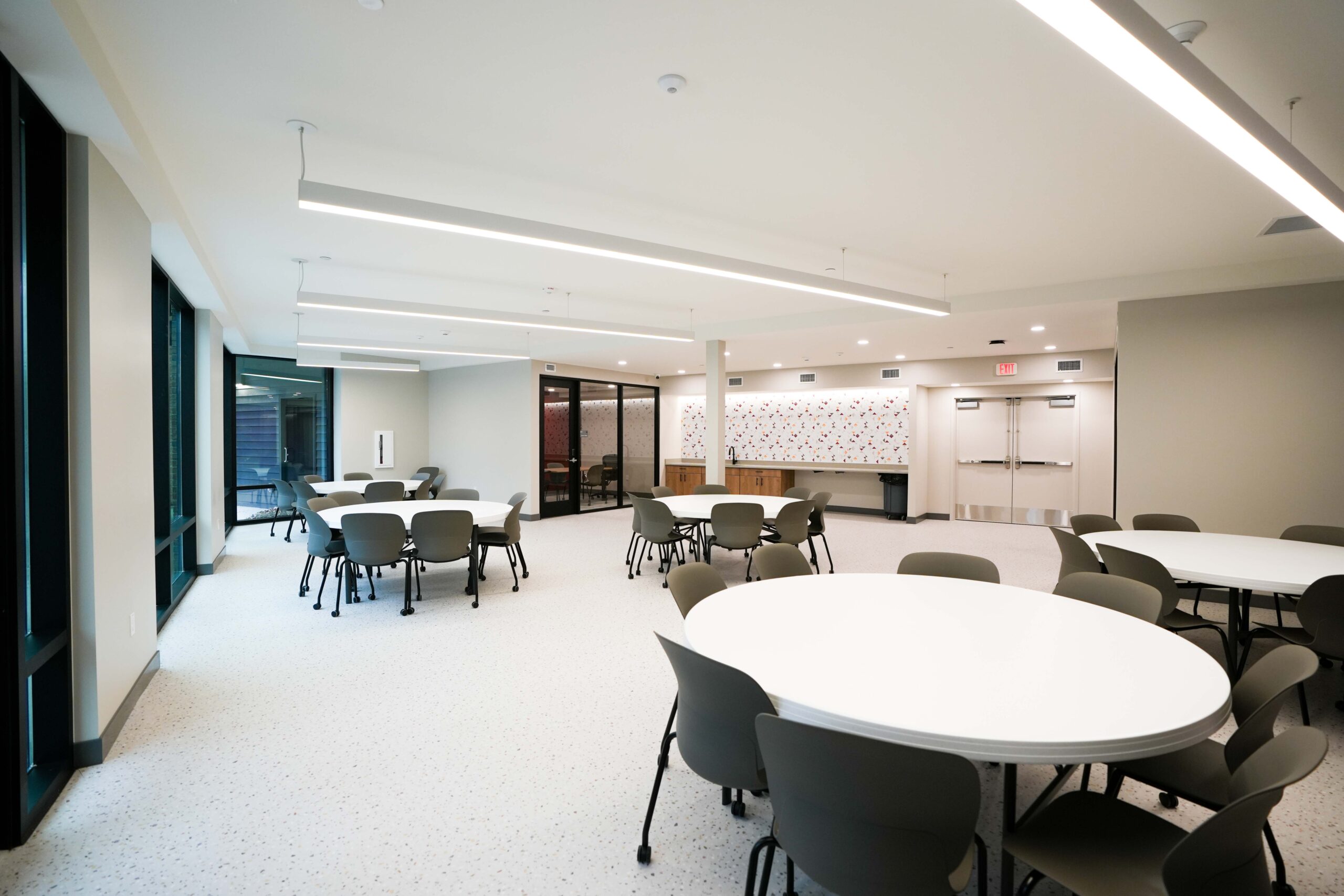 Community room at Calvin Theological Seminary housing with integrated lighting and digital display installed by Buist.