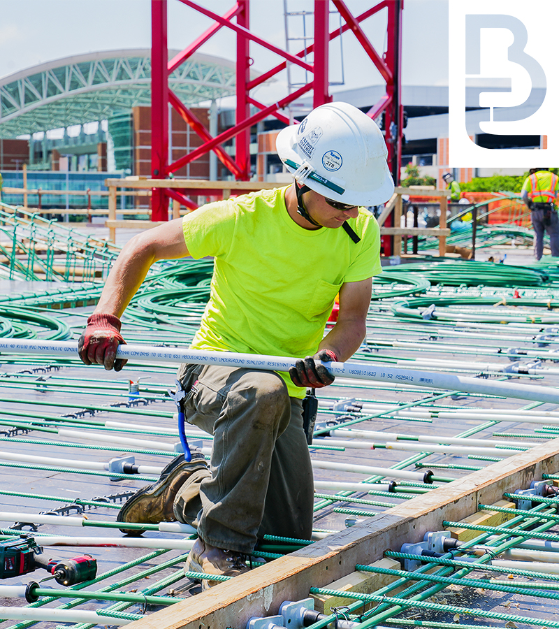 Buist employee holding conduit on a commercial electrical project.