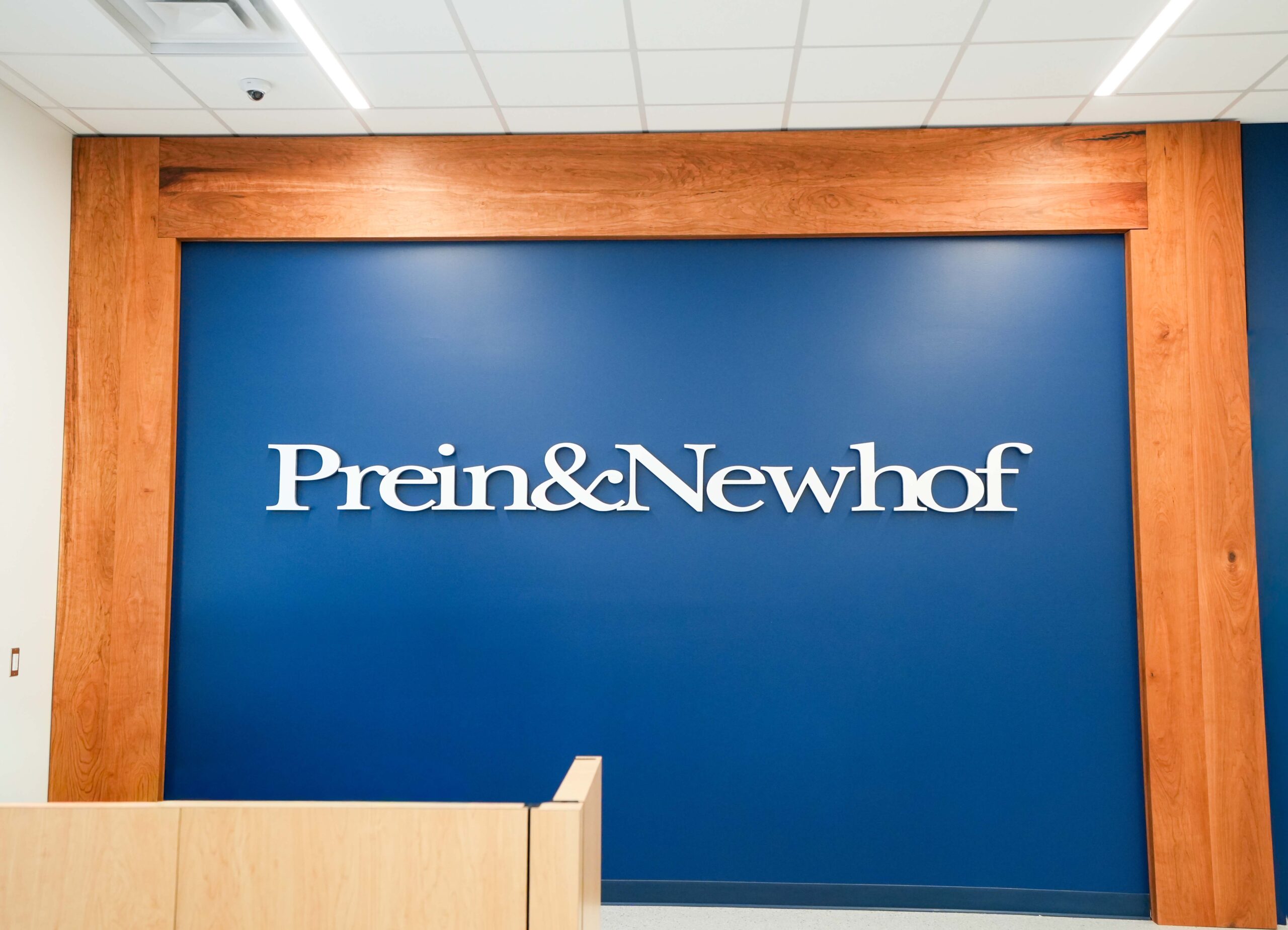 Prein&Newhof interior feature wall with company signage and architectural finishes.