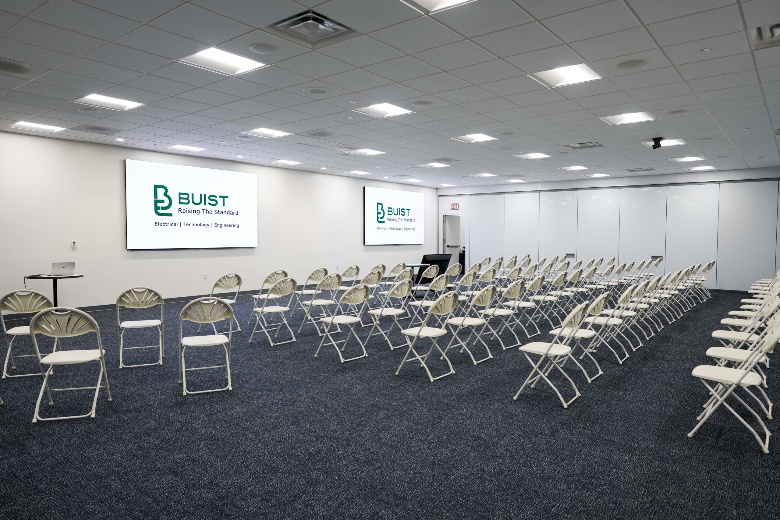 Audio visual installation by Buist in a GE Aerospace training room with dual displays and seating