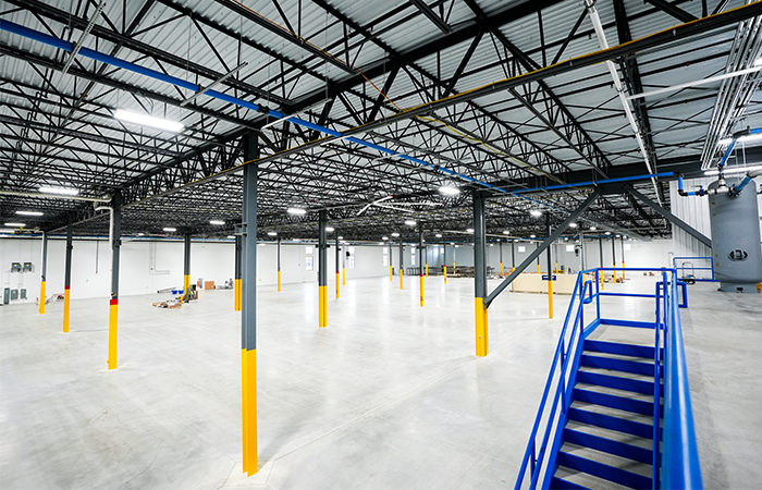 Wide view of Benteler Automotive manufacturing floor in Grand Rapids Michigan supported by communications infrastructure installed by Buist