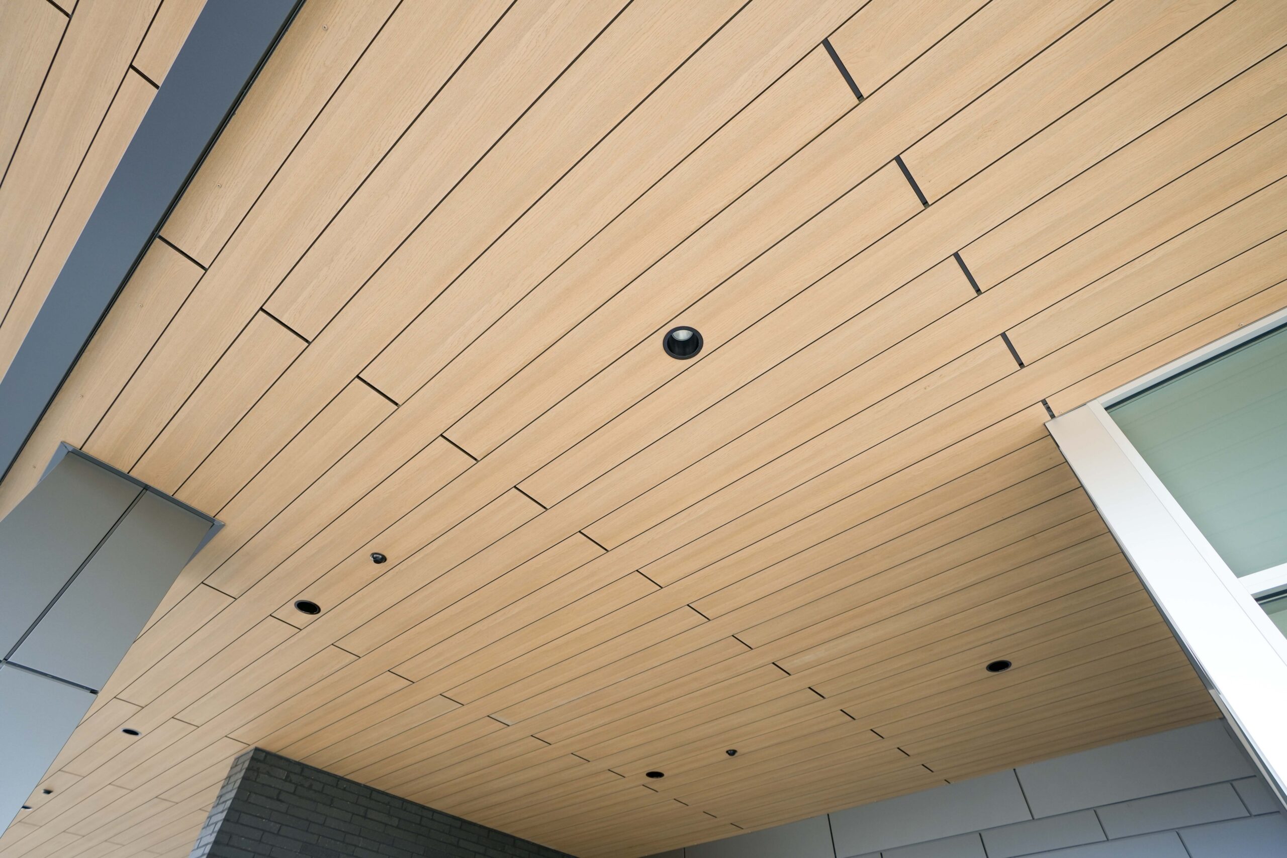 Wood soffit ceiling detail under entrance canopy at Corewell Health Endoscopy Facility Grand Rapids Michigan