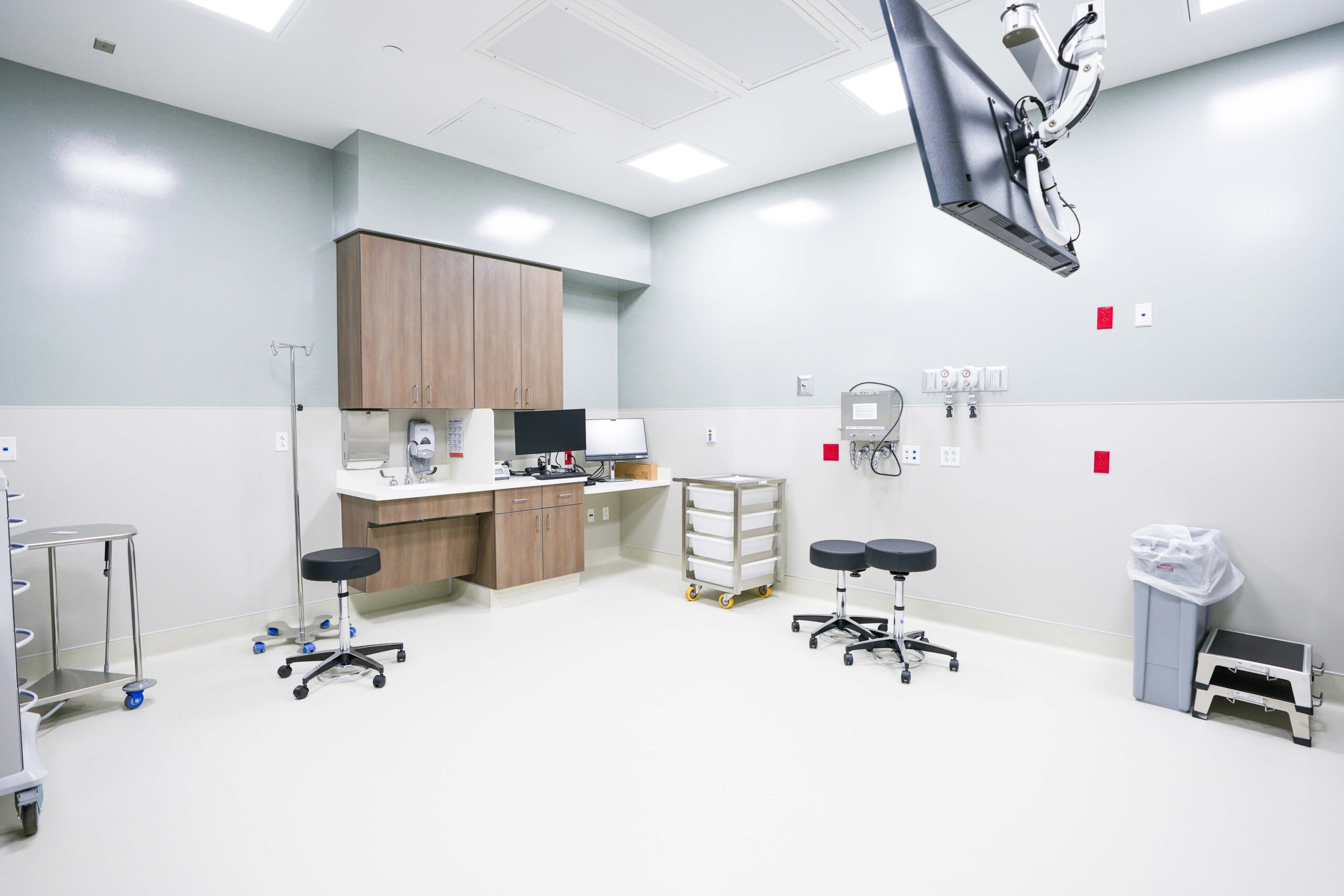Medical procedure room with ceiling mounted monitor and clinical workstations in Grand Rapids Michigan