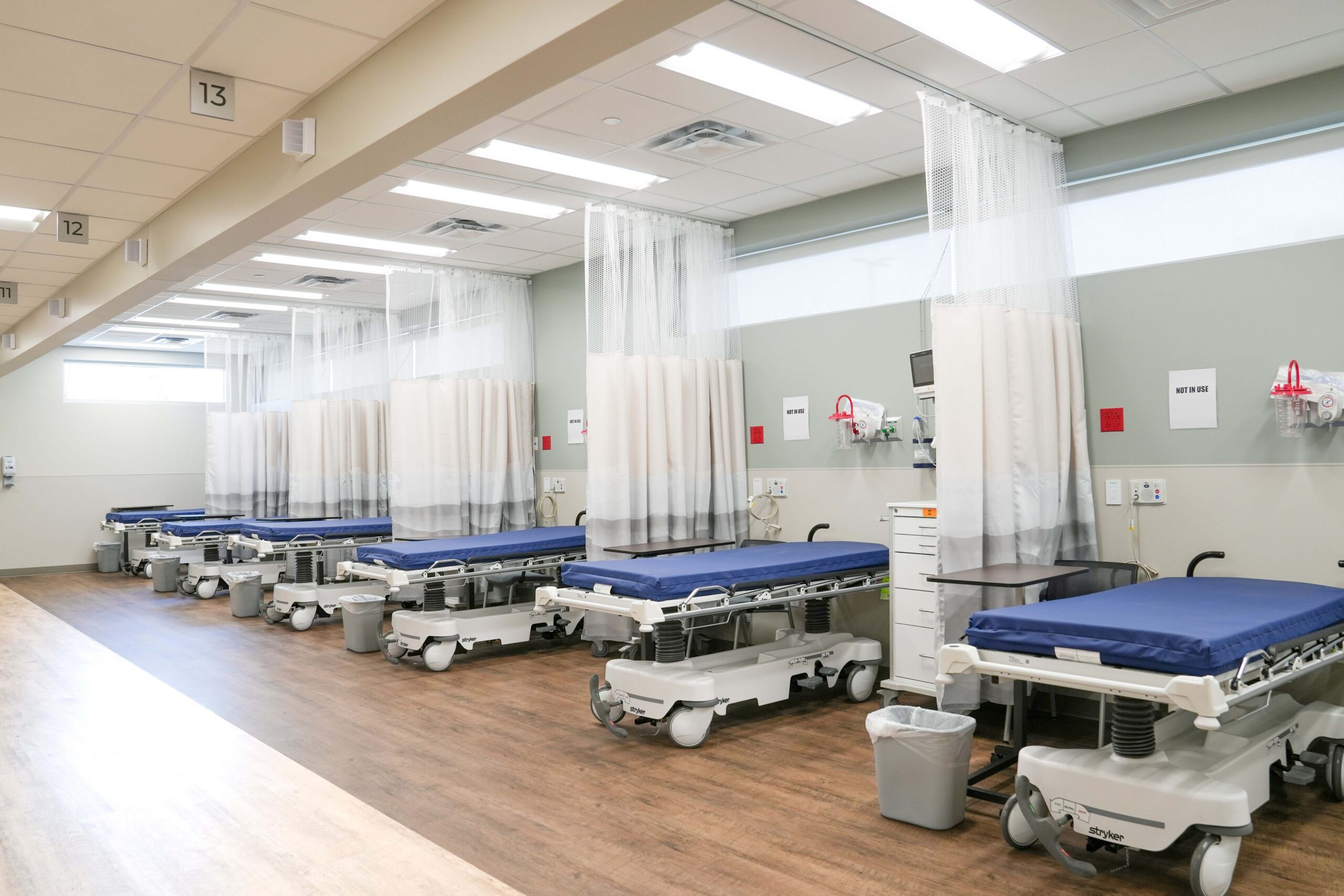 Recovery bays with hospital beds and privacy curtains at Corewell Health Endoscopy Facility in Grand Rapids Michigan