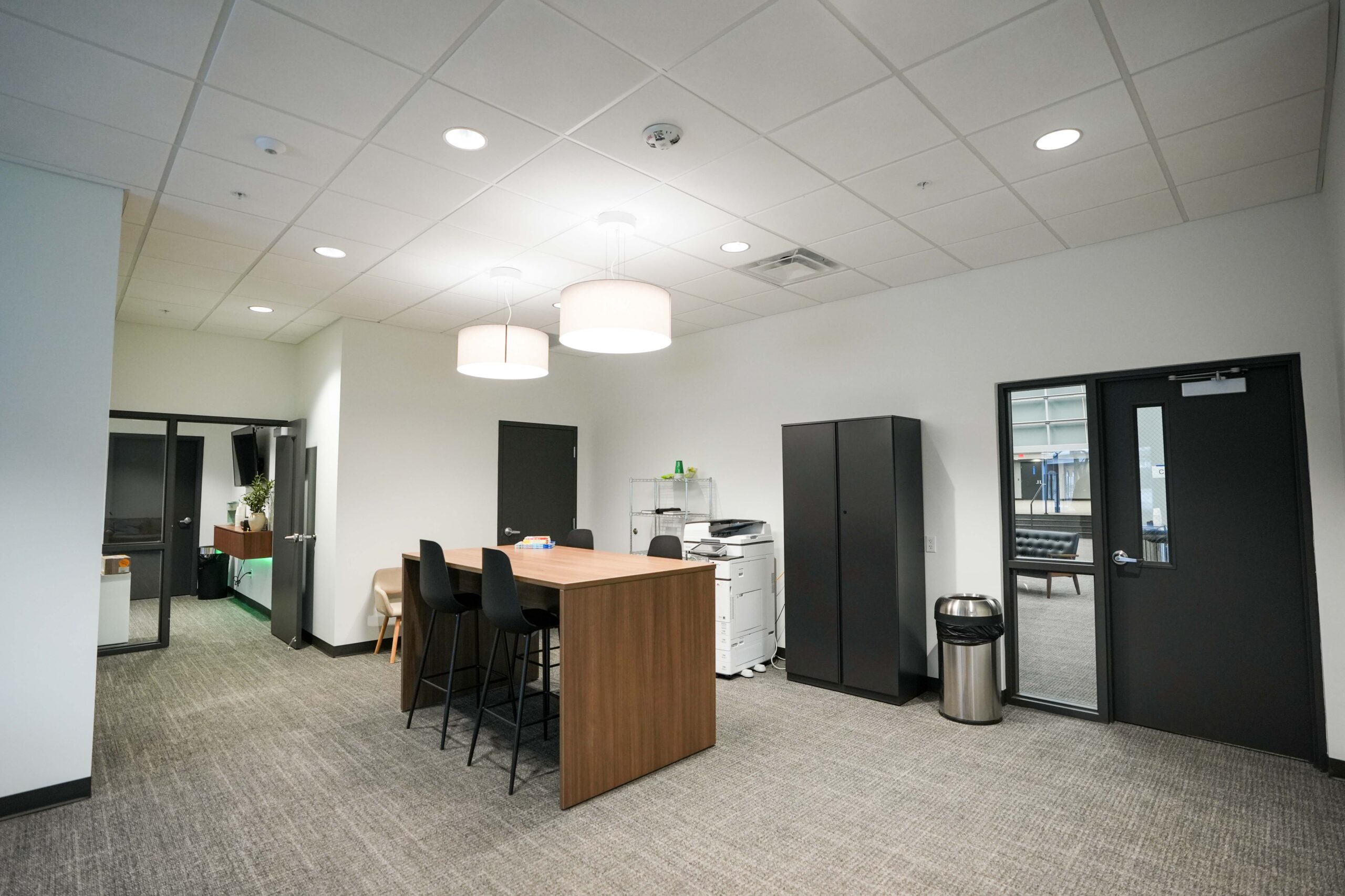 Church office collaboration area with table seating and pendant lighting