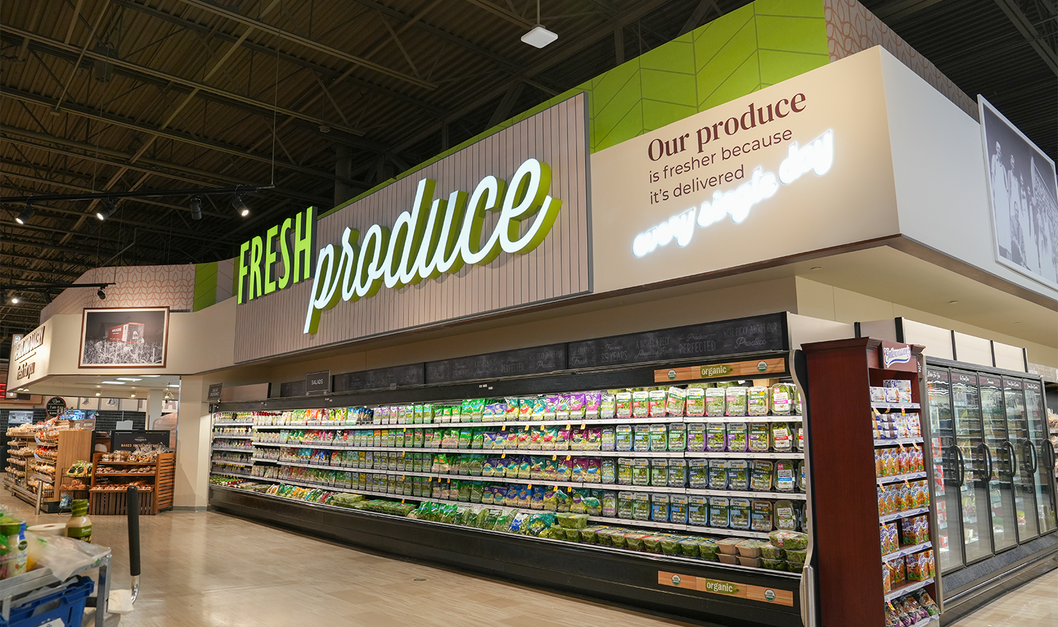 Fresh produce department featuring illuminated signage and upgraded lighting.