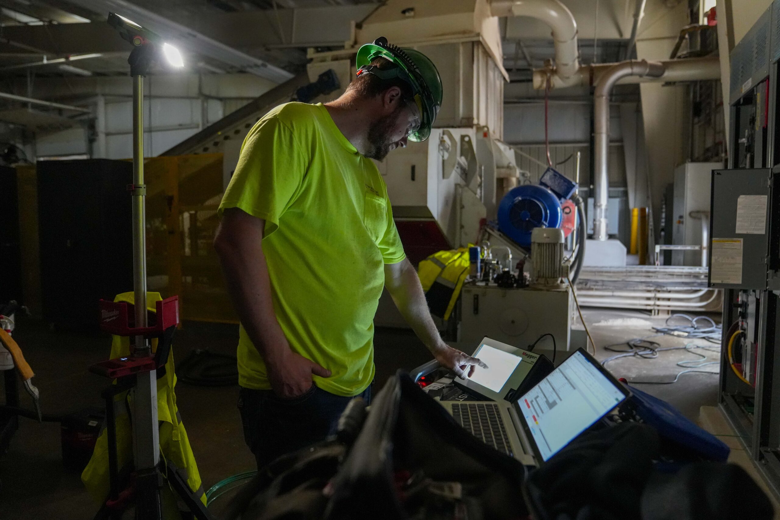 Buist technician operating diagnostic electrical testing equipment during a commercial facility shutdown.