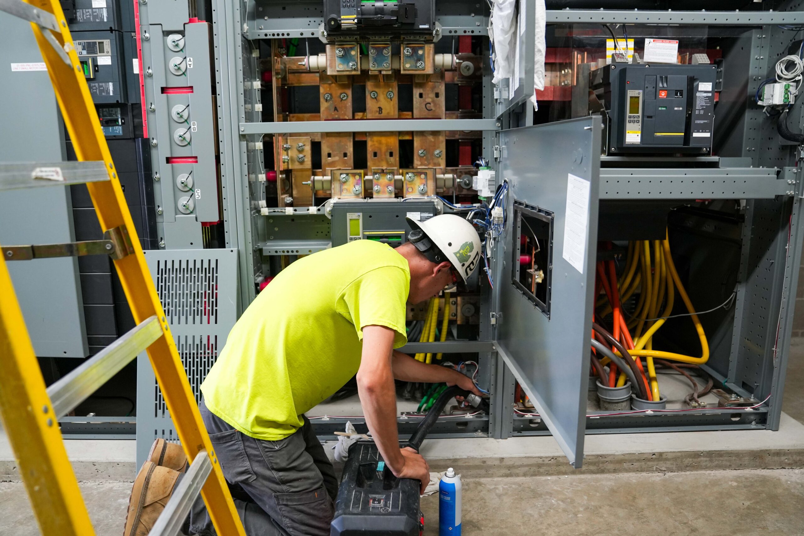 Buist technician cleaning and inspecting switchgear components during preventative electrical maintenance.