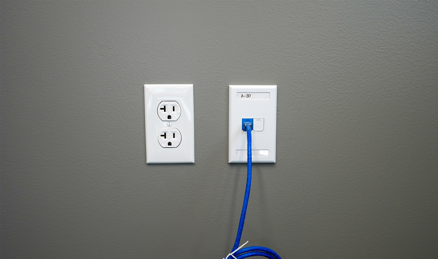 Electrical outlet and Cat6 data connection installed in a Burgess Concrete Construction office space by Buist's Contracting and Communications teams.
