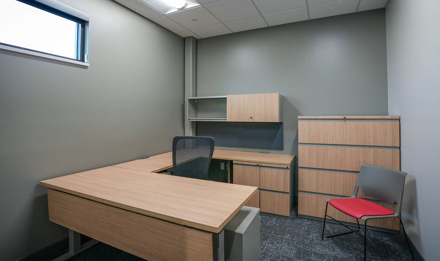 Private office at Burgess Concrete Construction featuring modern office furniture, integrated power, and lighting installed as part of the renovation project.