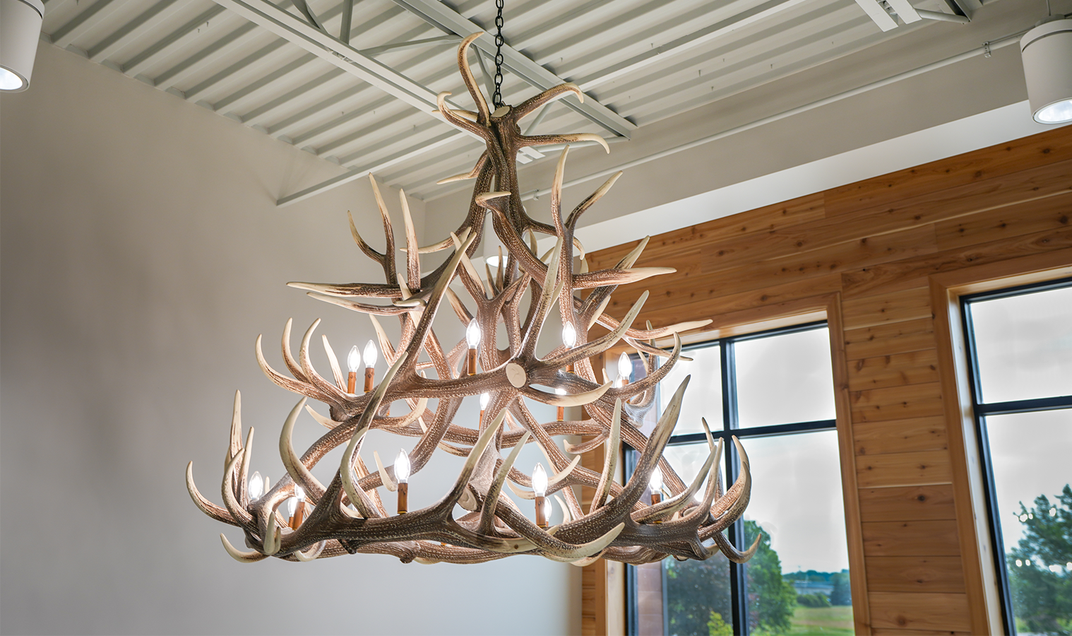 Decorative elk antler chandelier installed in the entryway of Burgess Concrete Construction's office addition.