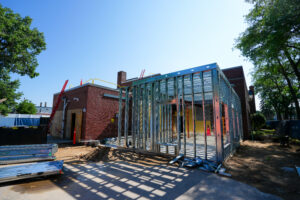 Exterior of the Alpha Grand Rapids addition under construction with new metal framing.