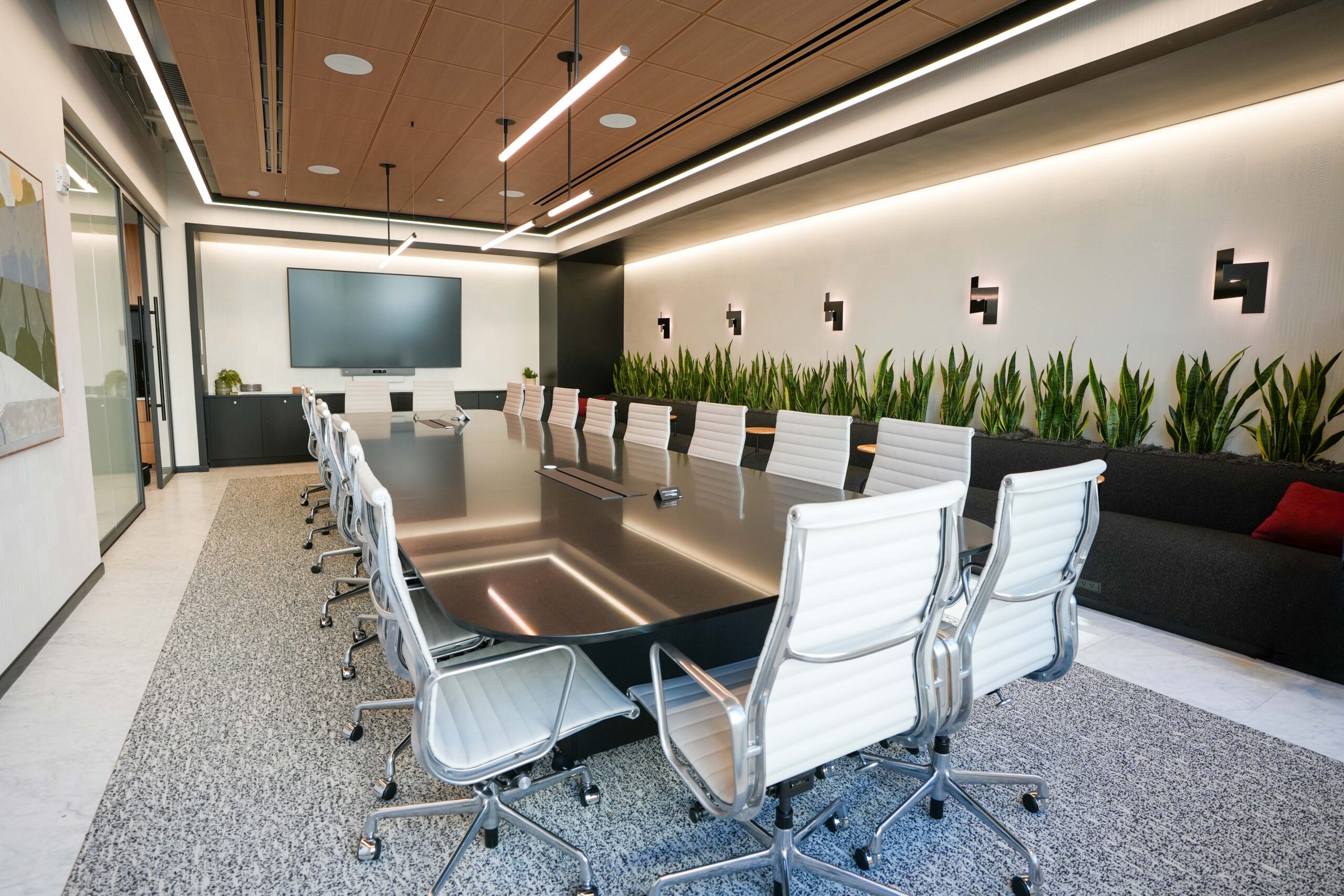BDO conference room with linear LED lighting integrated into a wood slat ceiling.