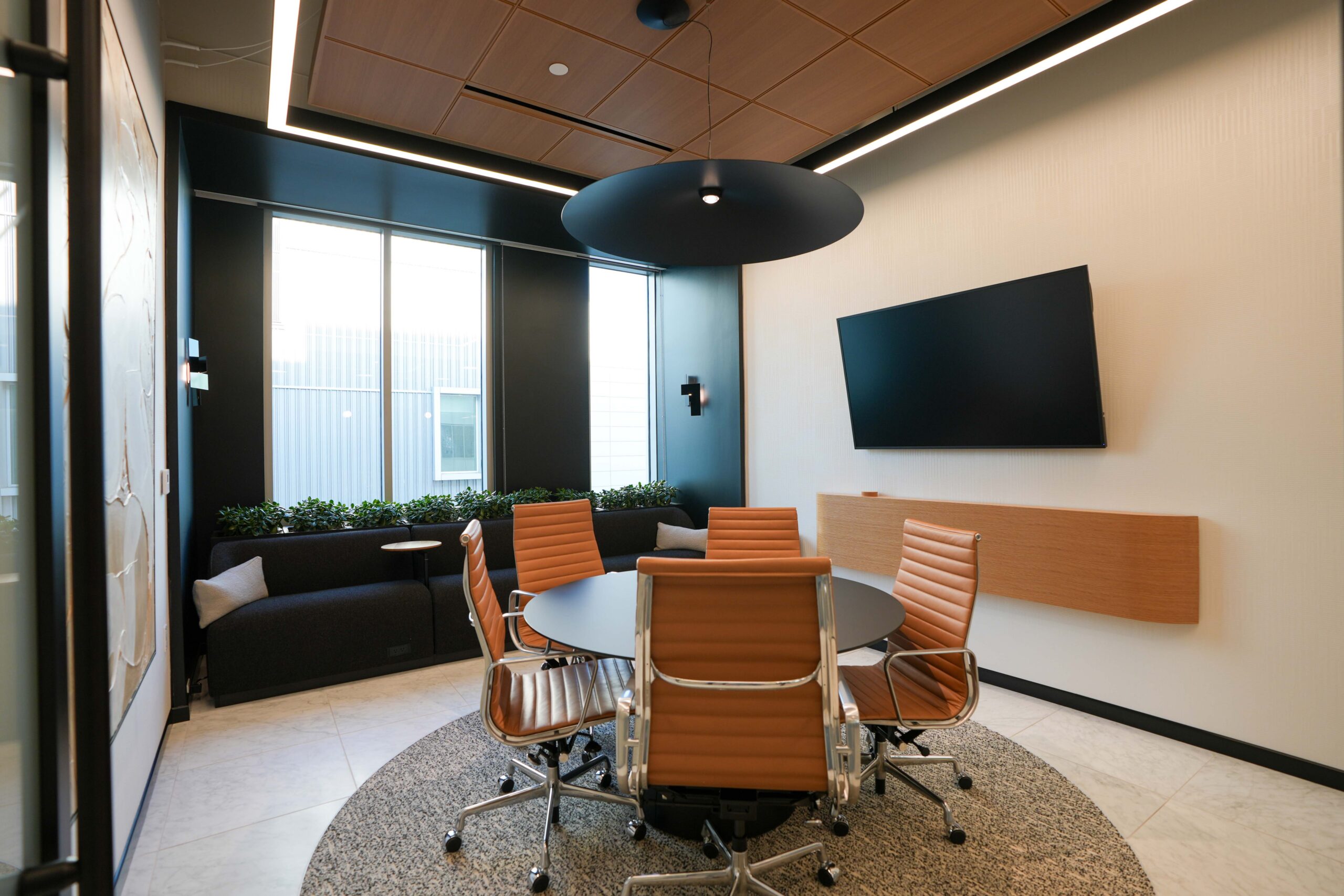 BDO conference room with linear LED lighting integrated into a wood slat ceiling.