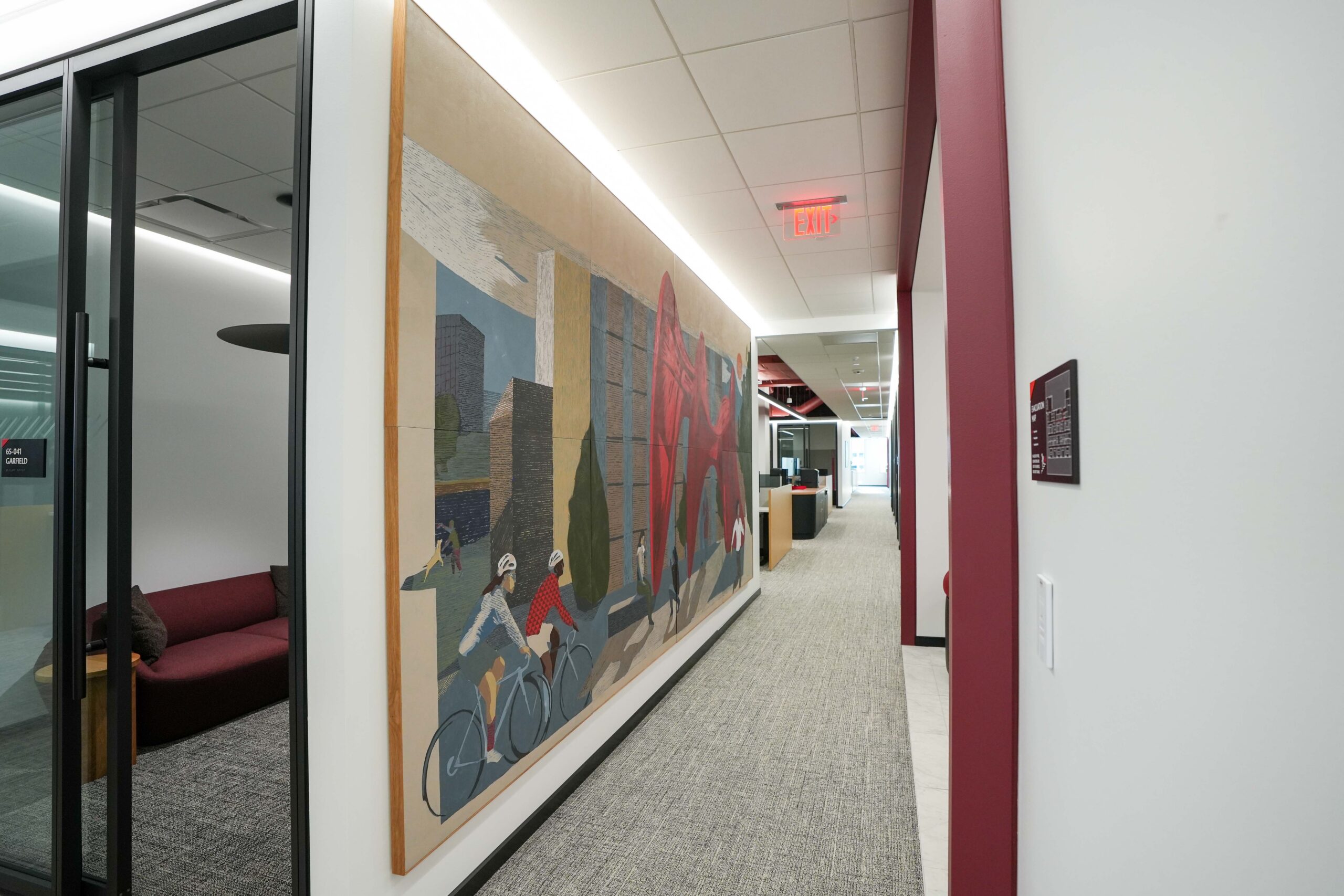 Hallway inside BDO’s Grand Rapids office featuring integrated linear lighting and artwork.