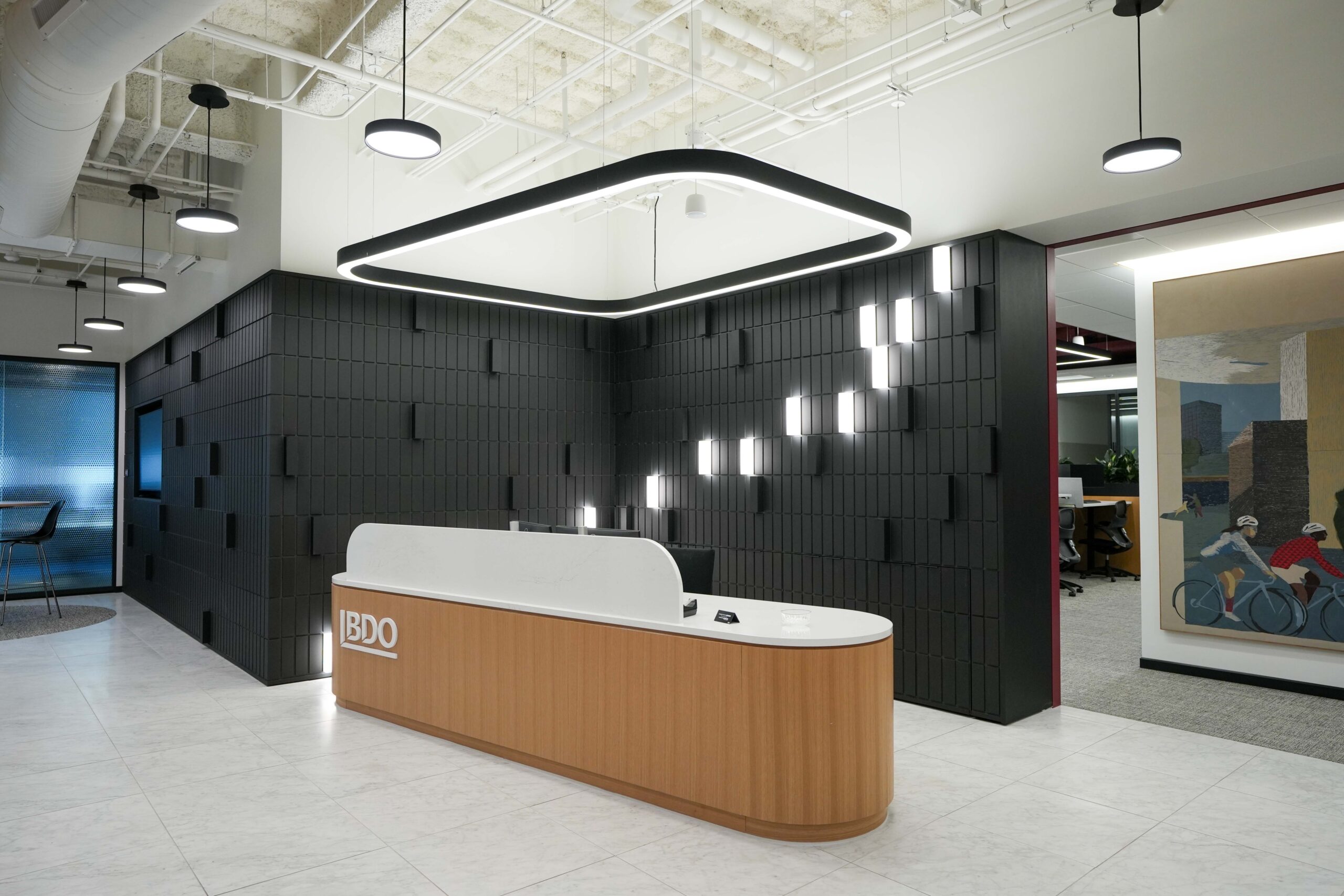BDO reception desk with architectural LED lighting and illuminated feature wall.