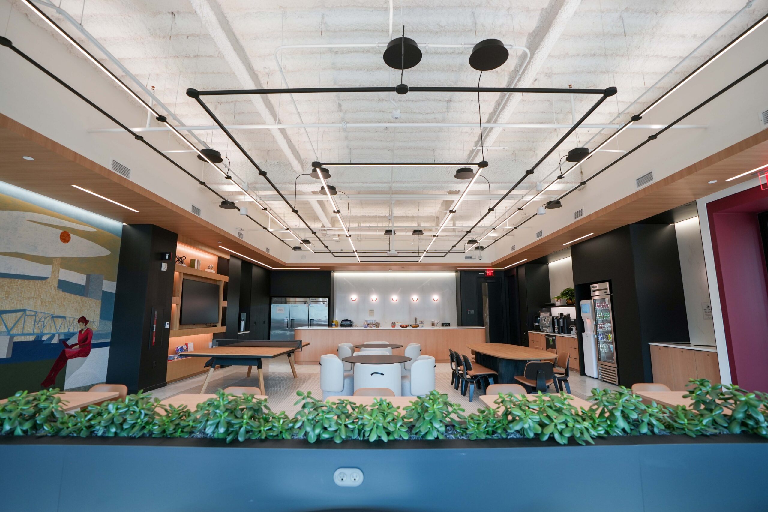 BDO Grand Rapids breakroom featuring architectural lighting, open ceilings, and collaborative seating.